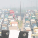 Vehicles ply on a road amid low visibility due to smog in New Delhi