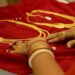 Agartala: A woman takes a look at a gold jewellery to buy ahead of Akshaya Tritiya festival, at a showroom in Agartala on Wednesday, Apr. 27, 2022.  (IANS/Abhisek Saha)