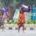 Bhubaneswar: Women carrying boxes cross the road amid heavy rain, in Bhubaneswar on Monday, March 27, 2023. (Photo: Biswanath swain/IANS)