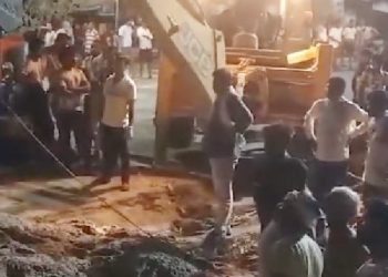 sand-laden truck overturns