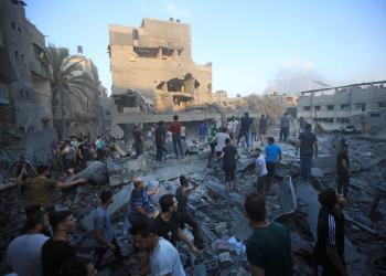 Palestinian inspect the destruction of a building following an Israeli airstrike on Gaza City, October 11, 2023. On the morning of October 7, the Palestinian resistance led by Hamas launched a surprise attack called the Al-Aqsa Flood operation. After firing thousands of rockets towards the lands occupied in 48, hundreds of fighters from the Gaza Strip raided Israeli military facilities and settlements through land, air and sea. Hundreds of Israeli settlers were killed, thousands were injured and and unknown number were taken hostage. In response, Israeli colonial forces declared complete siege on the Strip, denying the enclave’s two-million residents access to food, water, fuel and electricity. Since, hundreds of airstrikes were launched, killing many hundreds. Tens of thousands of Gaza's residents were displaced as result of the bombings, many of them for the second or third time. 80% of the Strip's residents are refugees from towns and villages depopulated in 1948. As of the fifth day of fighting, at least 1,055 Palestinians were killed in the Gaza Strip and at least 23 more in the West Bank. At least 1,200 Israelis were killed.