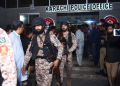 People examine a police building following an attack in Karachi, Pakistan, on Feb. 17, 2023. At least three attackers were killed and 10 people wounded on Friday night when a group of terrorists opened fire at a police building in Karachi, police and hospital officials said. (Str/Xinhua)