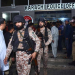 People examine a police building following an attack in Karachi, Pakistan, on Feb. 17, 2023. At least three attackers were killed and 10 people wounded on Friday night when a group of terrorists opened fire at a police building in Karachi, police and hospital officials said. (Str/Xinhua)