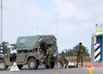 Israeli soldiers block a road near Sderot in southern Israel near the border with Gaza, on May 9, 2023. ((Ilan Assayag/JINI via Xinhua/IANS)