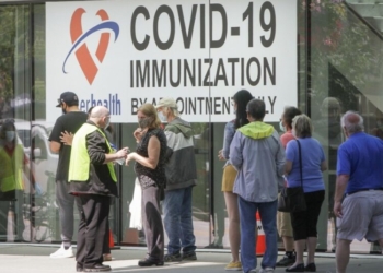 People line up outside a COVID-19 vaccination clinic in New Westminster, British Columbia, Canada, on June 18, 2021. (Photo by Liang Sen/Xinhua/IANS)