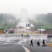 New Delhi: People walk in the rain as showers lash the national capital at India Gate in New Delhi on Thursday, July 31, 2025. (Photo: IANS/Qamar Sibtain)