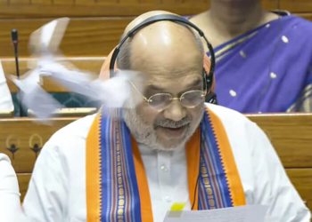 New Delhi: Paper bits allegedly thrown at Union Home Minister Amit Shah while he speaks in the Lok Sabha during the monsoon session of Parliament, in New Delhi on Wednesday, Aug 20, 2025. (Photo: IANS/Sansad TV)