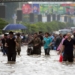 (250819) -- KARACHI, Aug. 19, 2025 (Xinhua) -- People wade through a flooded street after heavy monsoon rain in Karachi, Pakistan, on Aug. 19, 2025. (Str/Xinhua)