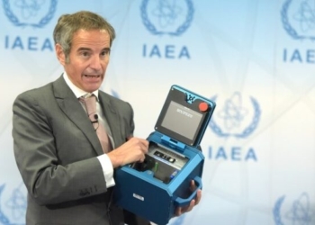 Rafael Mariano Grossi, Director General of the International Atomic Energy Agency (IAEA), displays a surveillance camera during a press conference in Vienna, Austria, Dec 17, 2021. (Xinhua/Guo Chen/IANS)
