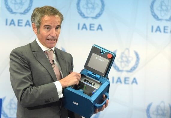 Rafael Mariano Grossi, Director General of the International Atomic Energy Agency (IAEA), displays a surveillance camera during a press conference in Vienna, Austria, Dec 17, 2021. (Xinhua/Guo Chen/IANS)