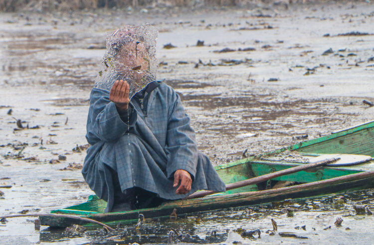 Srinagar: A boatman shows a frozen piece as major parts of the interior Dal Lake freeze partially after the minimum temperature dipped to minus four degrees (-4°_ Celsius in Srinagar on Tuesday, January 06, 2026. (Photo: IANS)