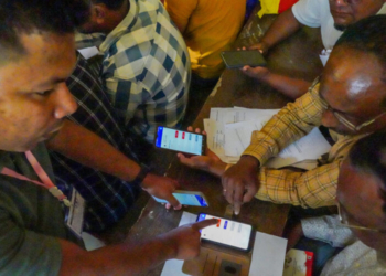 Morigaon: Demonstration of Electronic Voting Machine (EVM) and ECINET app is given to presiding and polling officers ahead of the Assembly elections in Morigaon on Friday, March 27, 2026. (Photo: IANS)