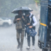 Noida: Commuters walk along a road holding an umbrella during sudden rainfall in the cold season, in Noida, Uttar Pradesh on Tuesday, January 27, 2026. (Photo: IANS)