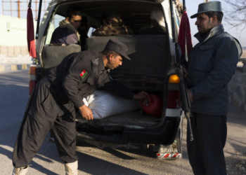 (190224) -- HERAT, Feb. 24, 2019 (Xinhua) -- An Afghan policeman (L, front) searches a vehicle at a security checkpoint along Herat-Farah main road in Herat, Afghanistan, Feb. 24, 2019. Afghan security forces have killed nine Taliban militants and seized nearly 900 kg narcotic drugs during separate operations, the Afghan Ministry of Interior Affairs said Saturday. In Herat province, the Afghan National Police (ANP) seized more than 570 kg of narcotics and opium and a vehicle after the ANP laid an ambush and engaged with drug traffickers along a main road. (Xinhua/Elaha Sahel)