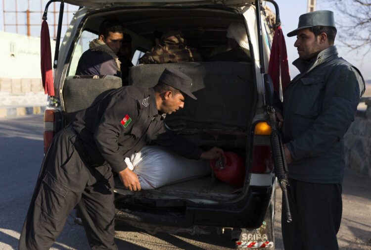 (190224) -- HERAT, Feb. 24, 2019 (Xinhua) -- An Afghan policeman (L, front) searches a vehicle at a security checkpoint along Herat-Farah main road in Herat, Afghanistan, Feb. 24, 2019. Afghan security forces have killed nine Taliban militants and seized nearly 900 kg narcotic drugs during separate operations, the Afghan Ministry of Interior Affairs said Saturday. In Herat province, the Afghan National Police (ANP) seized more than 570 kg of narcotics and opium and a vehicle after the ANP laid an ambush and engaged with drug traffickers along a main road. (Xinhua/Elaha Sahel)